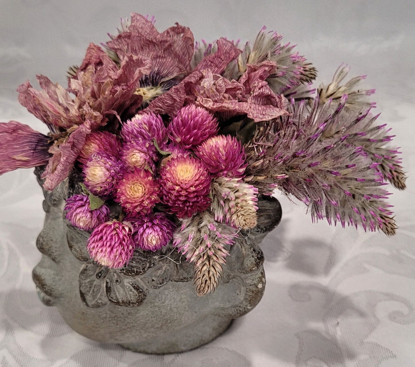 Dried flowers in a Cement Head Vase