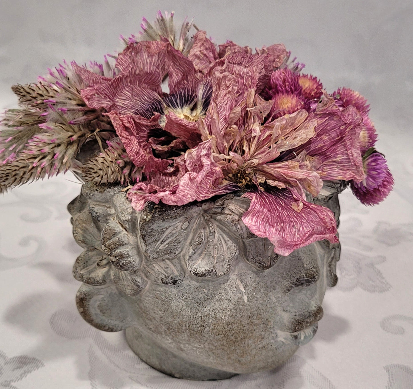 Dried flowers in a Cement Head Vase