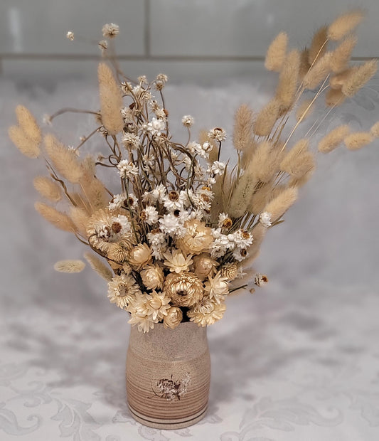 Dried flowers in a ceramic vase