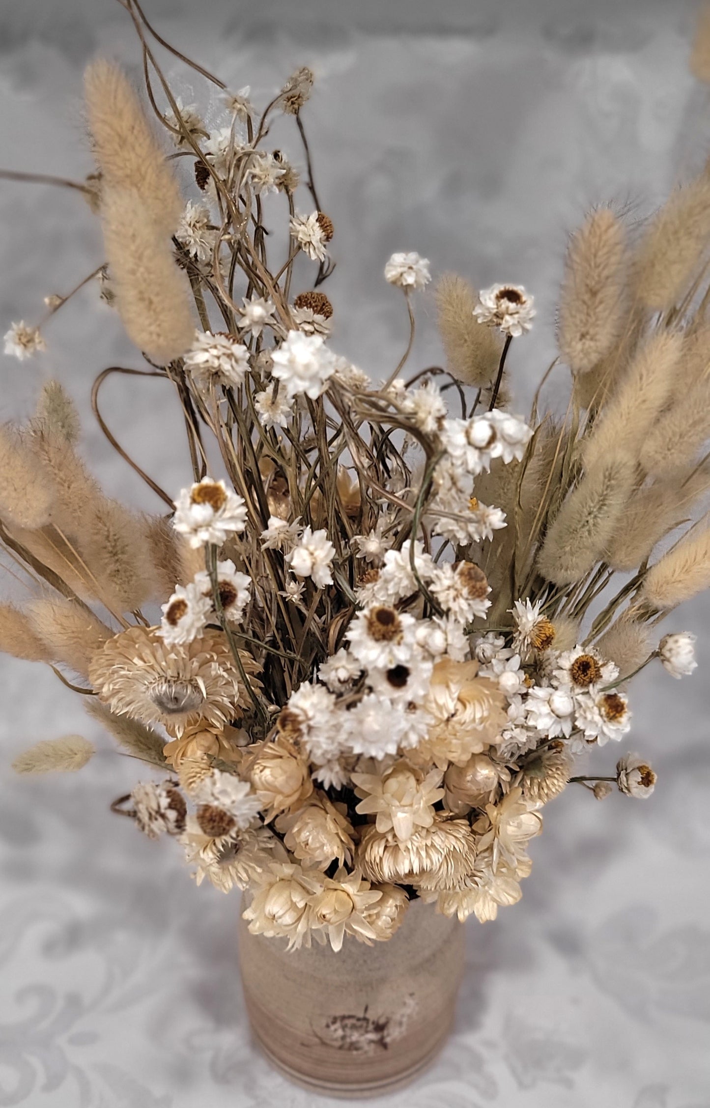Dried flowers in a ceramic vase
