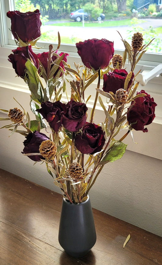 Dried Red Roses in a ceramic vase